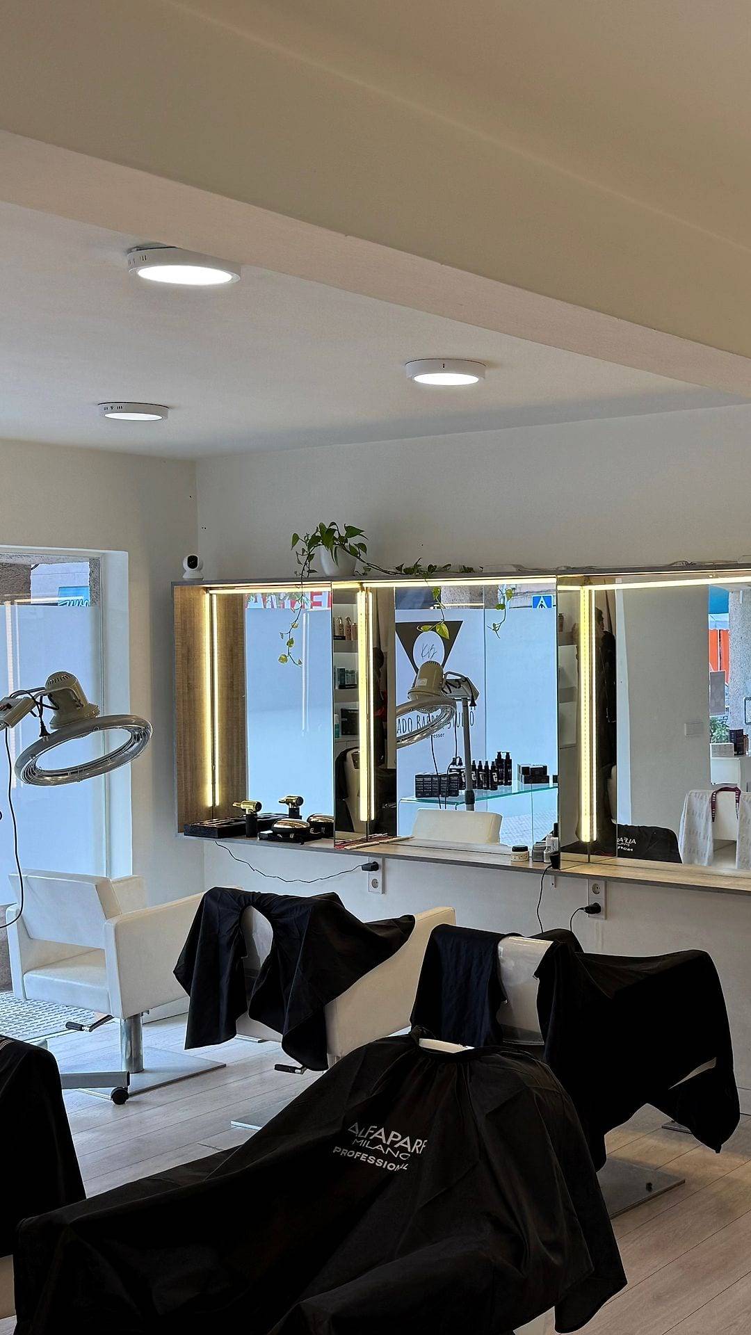 El salón: sillones de corte frente a una pared de espejos con luz integrada